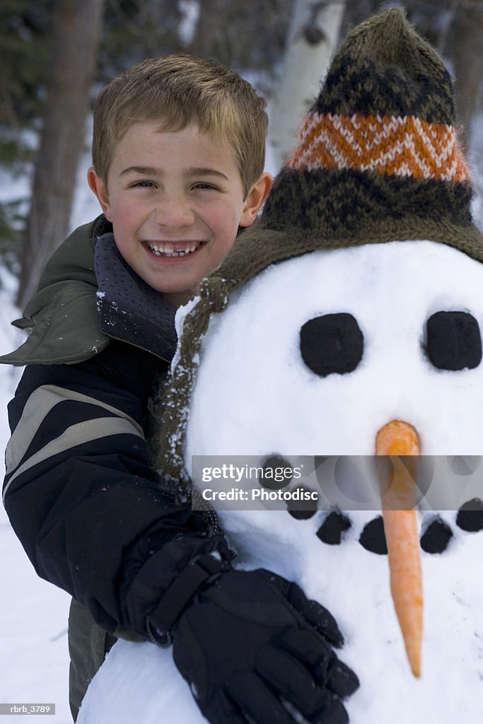 Portrait of a boy (6-7) with a snowman