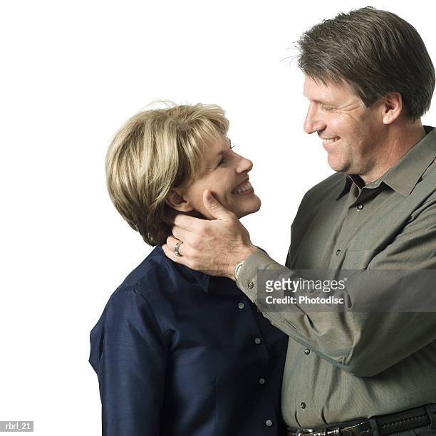 an adult caucasian couple smile as they lovingly look into each others eyes - smile bildbanksfoton och bilder