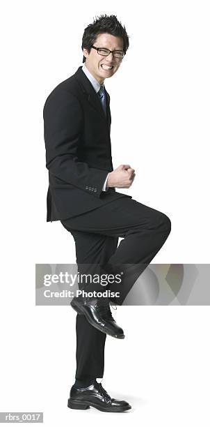full body shot of a young adult business man as he celebrates a job well done - man full body isolated stock pictures, royalty-free photos & images