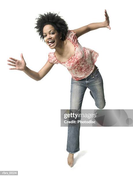 low angle full body shot of a young adult woman as she playfully jumps around - dancing funny carefree woman stock pictures, royalty-free photos & images