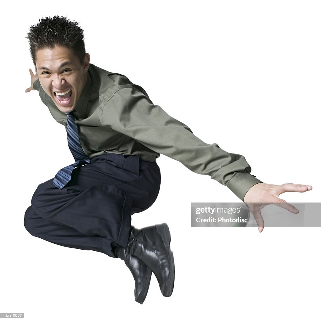 Full body shot of a young adult male in a shirt and tie as he jumps up in the air