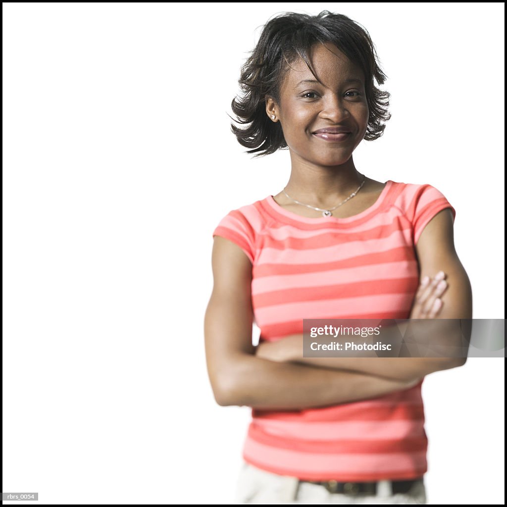 Medium shot of a young adult female in a striped shirt as she folds her arms and smiles