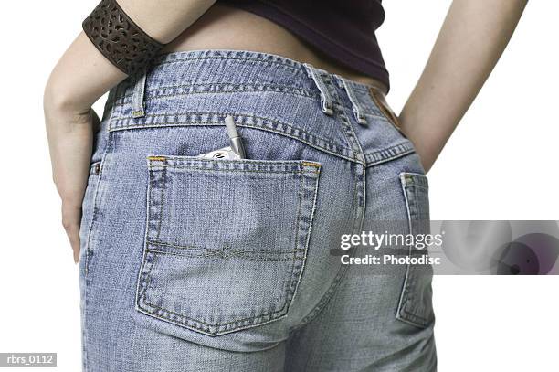 close up shot of a small cell phone in the back pocket of a teenage female - phone in back pocket stock pictures, royalty-free photos & images