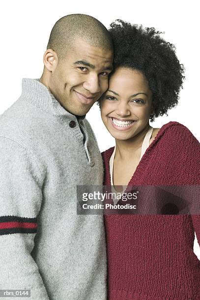 medium shot of a young adult couple as they smile at the camera - smile stock-fotos und bilder