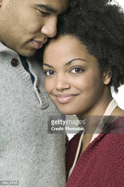 medium close up of a young adult woman as she snuggles up next to her boyfriend - next imagens e fotografias de stock