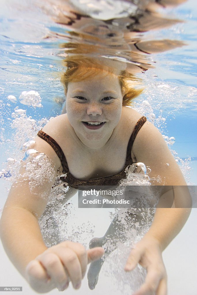 Underwater photo of a female child as she swims in a pool