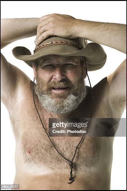 real people portrait of an adult man with no shirt and a hat as he looks at the camera - no stock pictures, royalty-free photos & images