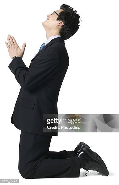 full body portrait of a young adult male in a suit as he gets down on his knees and begs - man full body isolated stock pictures, royalty-free photos & images
