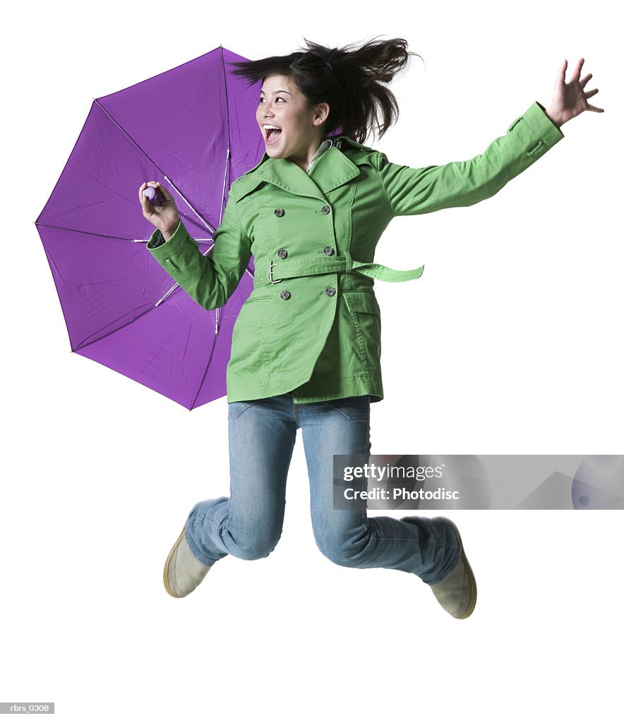 Teenage girl jumping with an umbrella