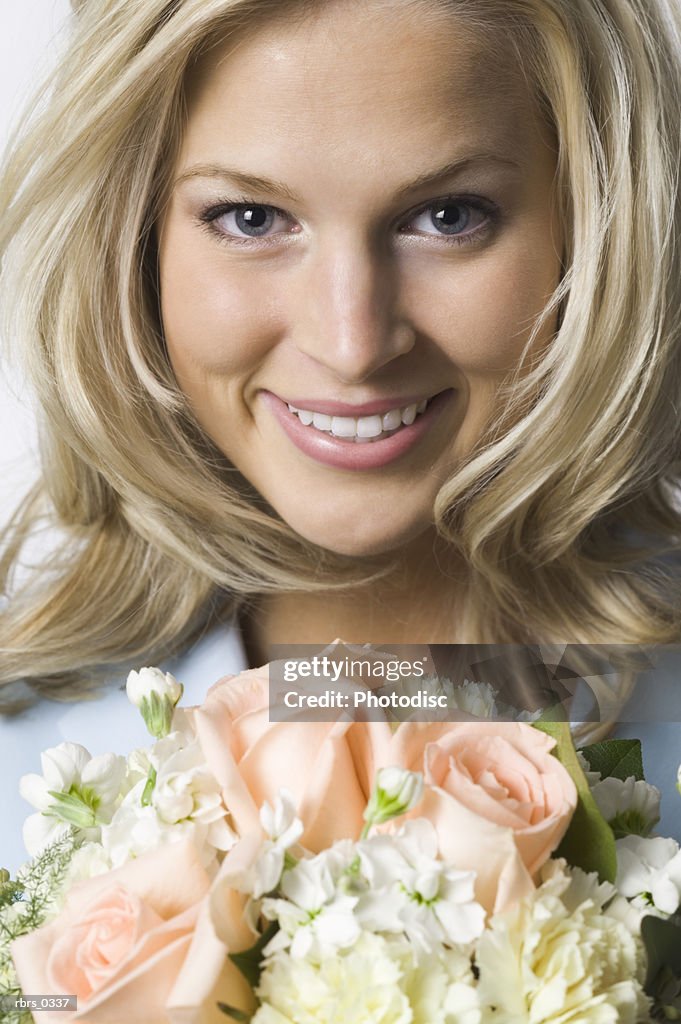 Portrait of a young woman holding a bouquet of flowers