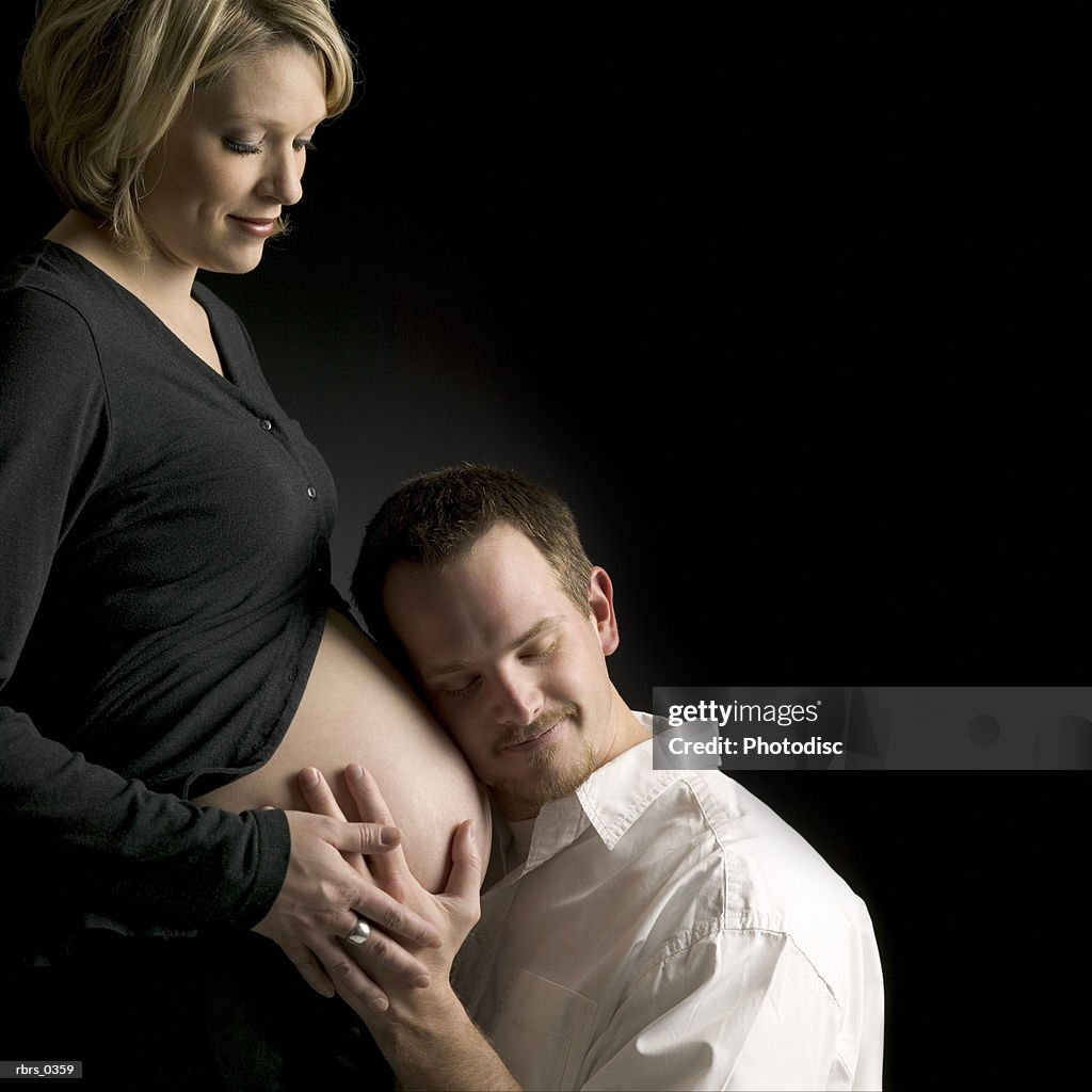 Man feeling a pregnant woman's stomach