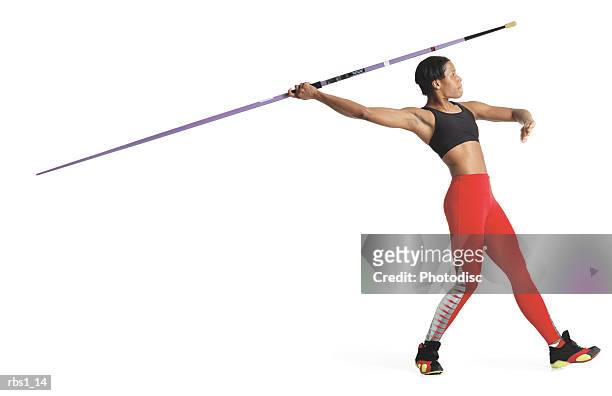 a young black woman is wearing a red track uniform and preparing to throw a javelin - women's field event 個照片及圖片檔