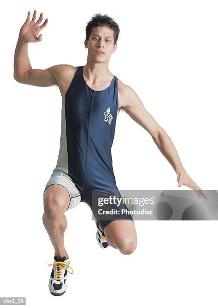 a young bruenette caucasian man in a blue and white track suit jumps high as he attemps the long jump - mens field event 個照片及圖片檔