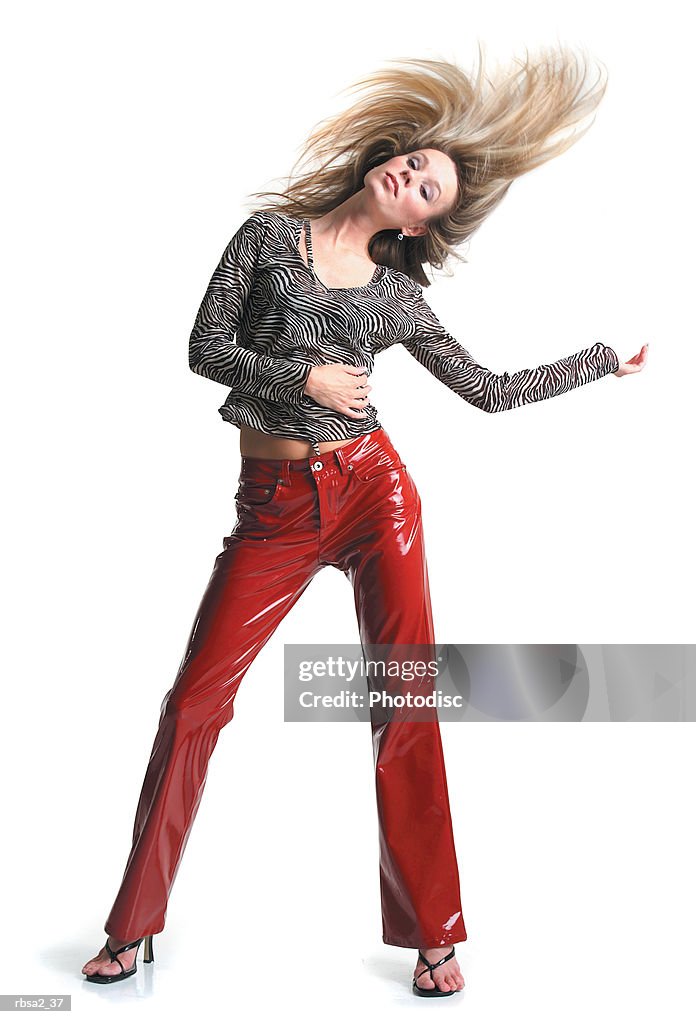 Young Attractive Blonde Caucasian Woman In Red Leather Pants Dances And  Playfully Tosses Her Hair High-Res Stock Photo - Getty Images