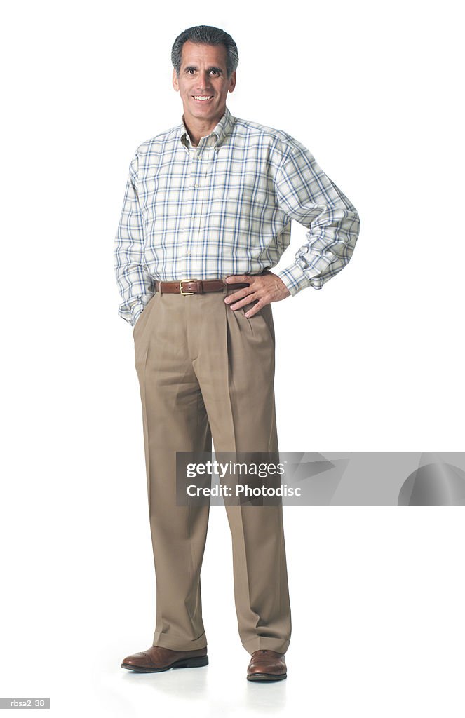 An adult caucasian man in tan pants and a plaid shirt smiles into the camera