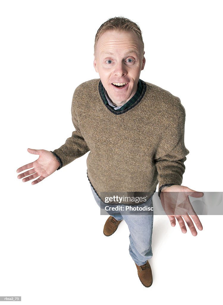 Adult caucasian man dressed in jeans and green sweater gestures with his hands shrugs his shoulders