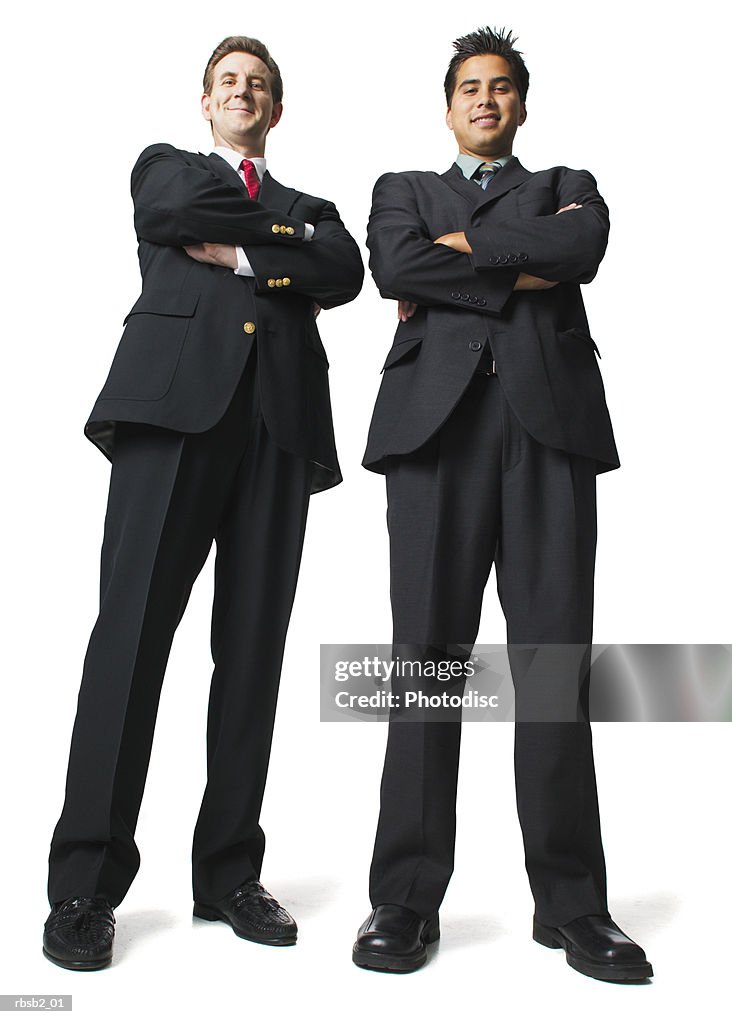 Low angle of two business men in suits as they fold their arms and smile