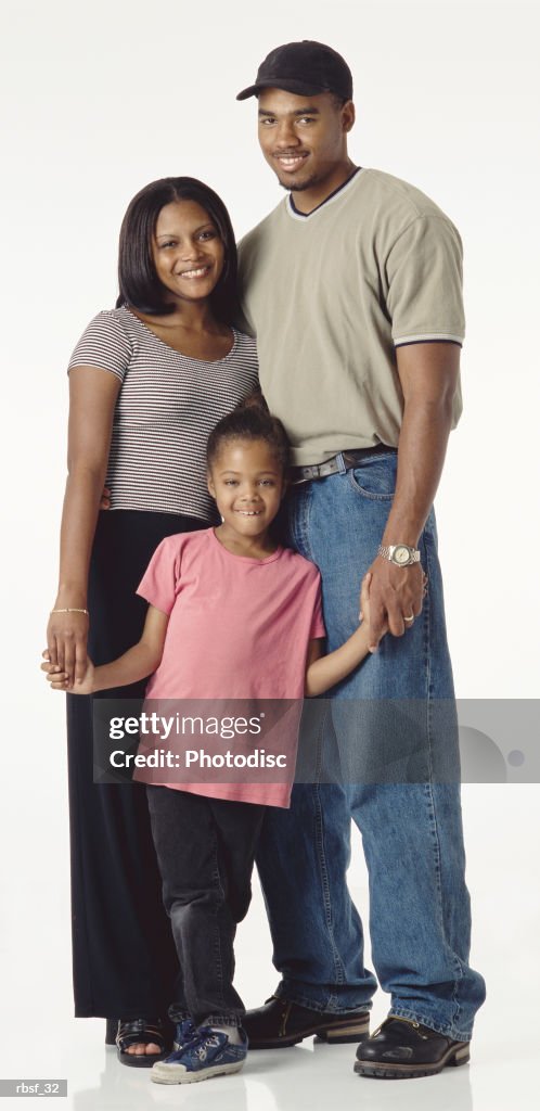 Young happy african american couple with preteen daughter stand together