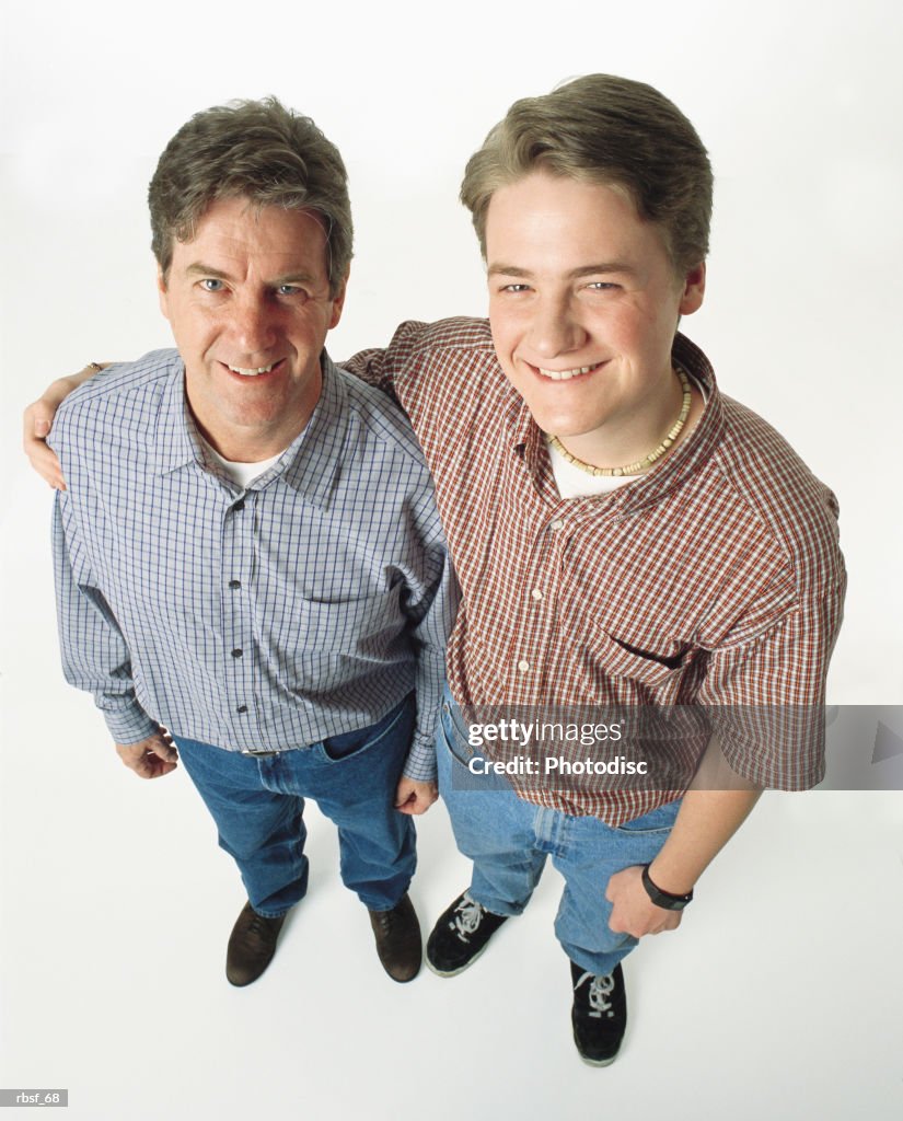 Caucasian dad with son putting his arm around him