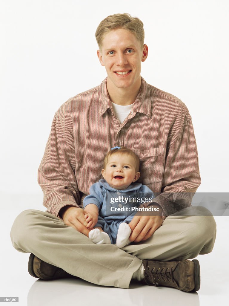 Caucasian blonde dad with infant in lap