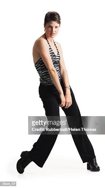 young caucasian female dancer in black pants ans a zebra print tank top dances as she throws her shoulder forward - thomas photos et images de collection