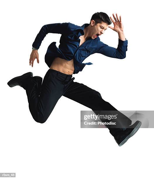 caucasian man with dark blue button down shirt and black pants jumping and running with angry look on his face and arms flailing - look down stock-fotos und bilder