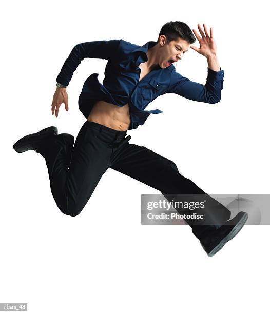 caucasian man with dark blue button down shirt and black pants jumping and running with angry look on his face and arms flailing - pants down bildbanksfoton och bilder