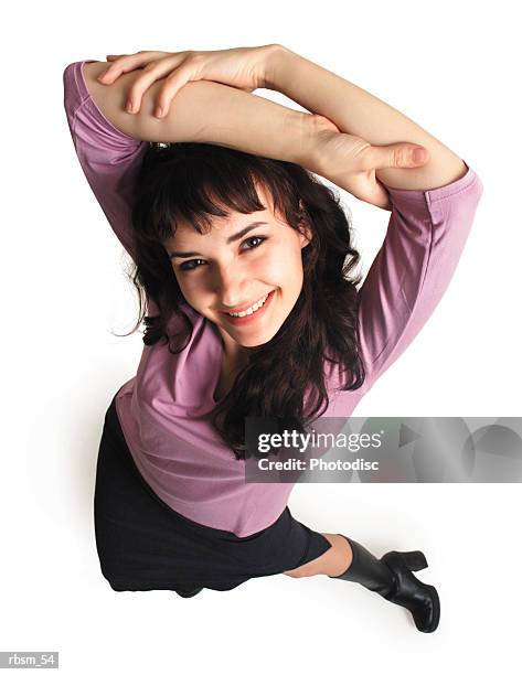 overhead of young female in black skirt purple blouse leaning out and lifting arms over her head - skirt stock pictures, royalty-free photos & images