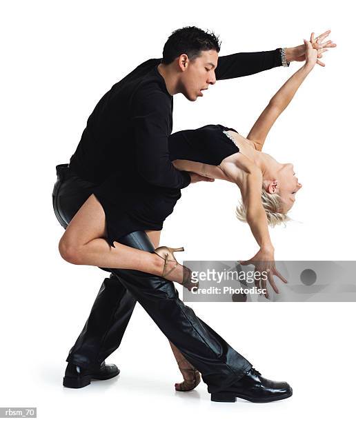 young dance couple latin male and a caucasian blonde both in a black hold each other in a tango pose - roupa de discoteca imagens e fotografias de stock
