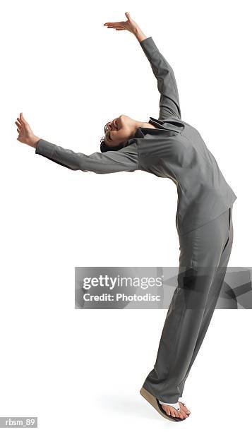 young latin female dancer grey suit leans forward tilts her head back throws her arms into the air - head forward white background imagens e fotografias de stock