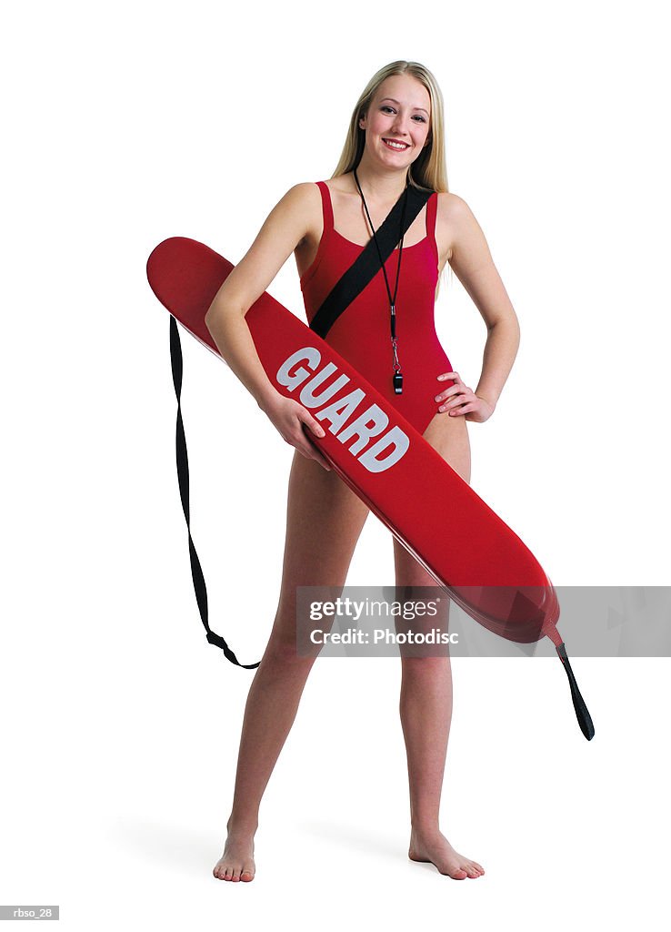 A young caucasian blonde female lifeguard stands posing with her rescue tube