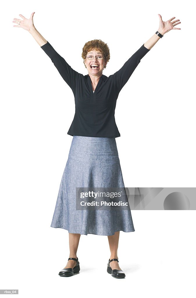 Silhouette of a caucasian woman excitedly  standing with her arms raised.