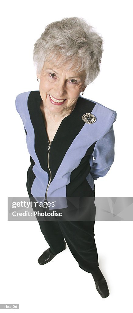 Birdseye view of an elderly woman smiling up at the camera.