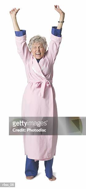 elderly woman in a bathrobe stretches. - olivia wilde co hosts event at birchbox soho in celebration of conscious commerce birchbox collaboration stockfoto's en -beelden