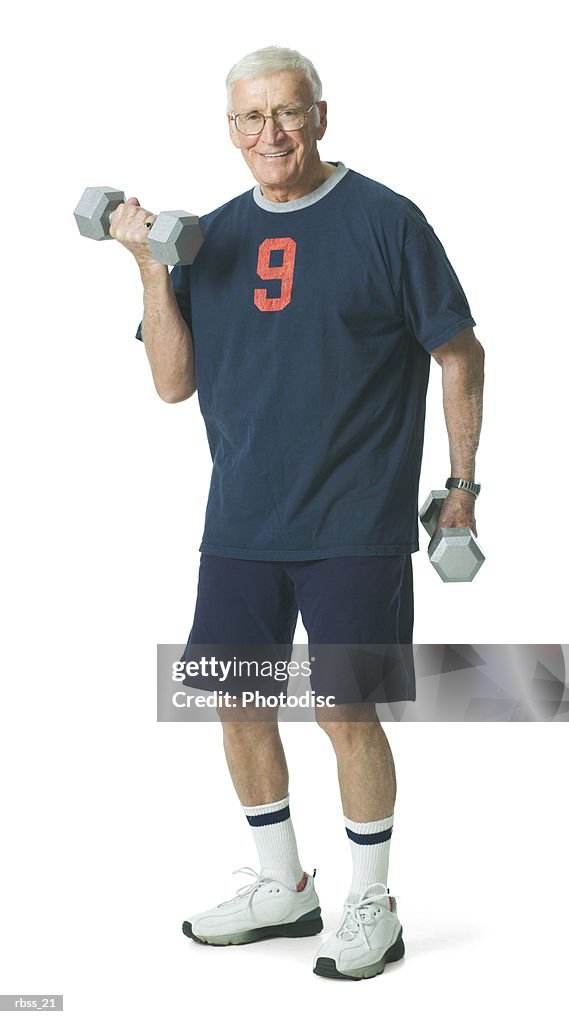 Elderly man smiles as he lifts weights.