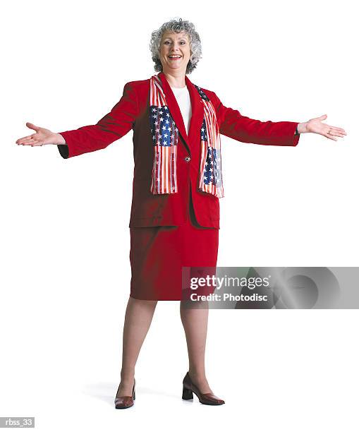 happy patriotic woman smiles wearing a red dress and an american flag scarf. - happy stockfoto's en -beelden