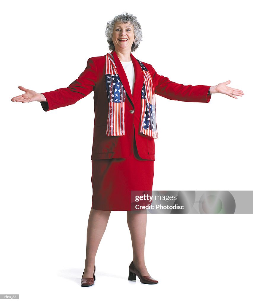 Happy patriotic woman smiles wearing a red dress and an American Flag scarf.