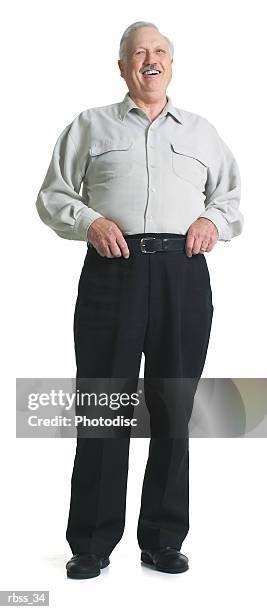 elderly man laughs while holding his belt. - belt stockfoto's en -beelden