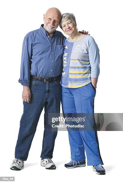 elderly couple smile as they lean together. - smile stockfoto's en -beelden