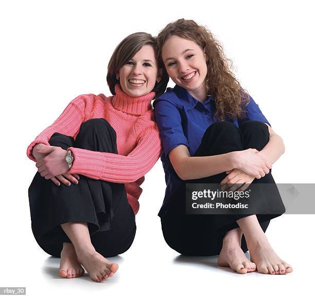 two caucasian teenage girls with bare feet sit down together and smile - smile imagens e fotografias de stock