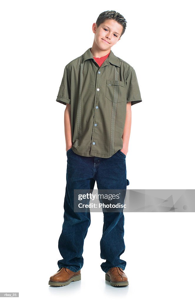 A caucasian teenage boy in jeans and a green shirt tosses his head to the side and smiles