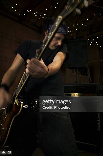 lifestyle portrait of a teenage male as he wildly plays his electric guitar - musician male energy imagens e fotografias de stock