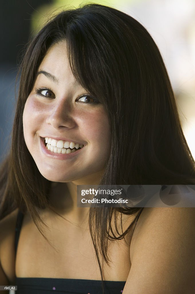 Lifestyle portrait of a teenage females as she flashes a funny grin at the camera