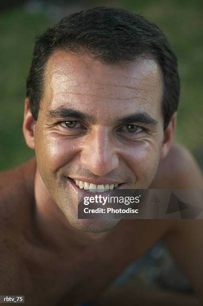 portrait of a caucasian man as he smiles on a beach while vacationing - windward islands stockfoto's en -beelden