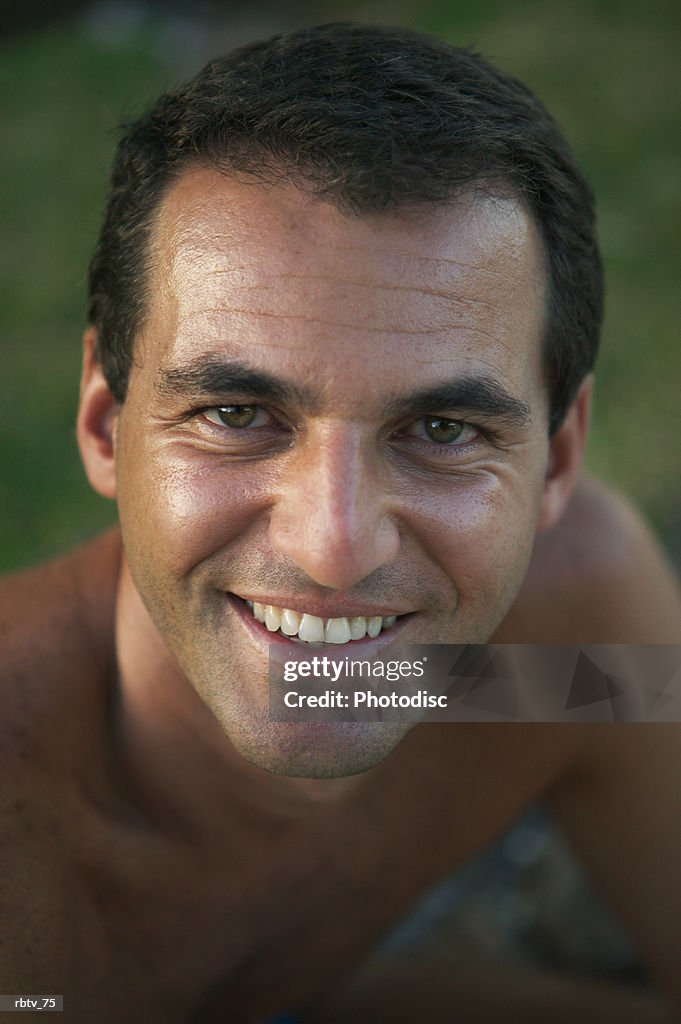 Portrait of a caucasian man as he smiles on a beach while vacationing