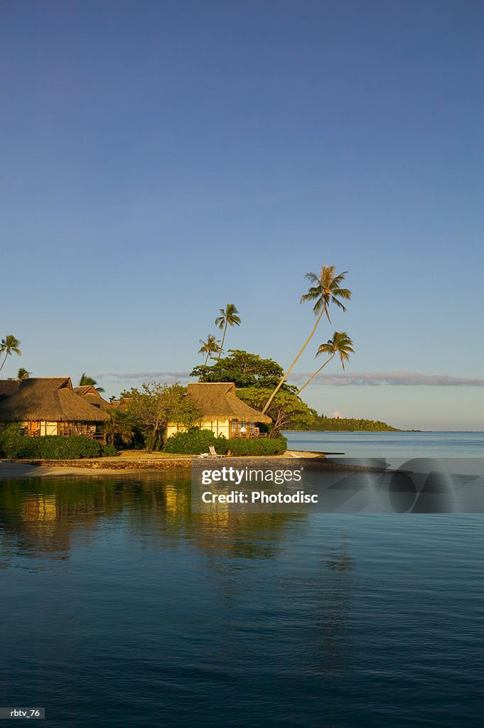 Landscape photograph of a beautiful beach and grass huts of a tropical resort