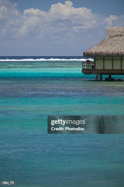 landscape photograph of a beautiful clear water and a grass hut - grashut stockfoto's en -beelden