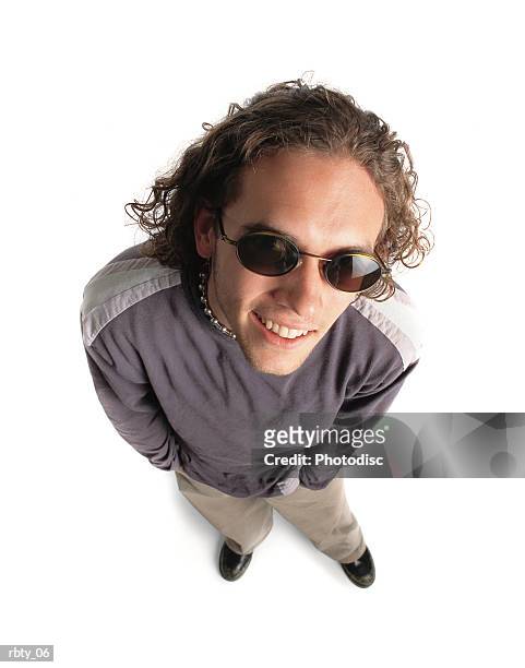 funky caucasian male with curly brown hair wearing alternative style clothing and sunglasses looks up and smiles - curly stock pictures, royalty-free photos & images