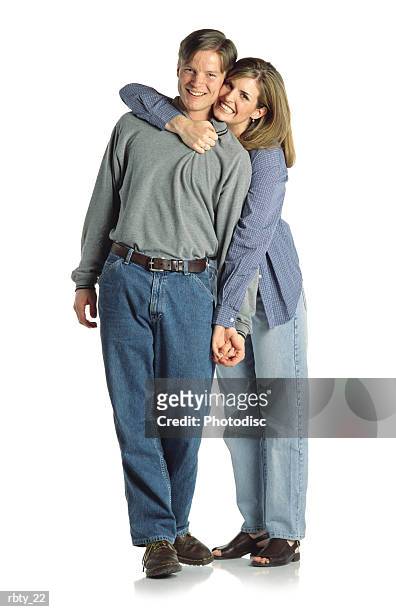 young brown-haired couple hold each other as they both smile happily - smile stock-fotos und bilder