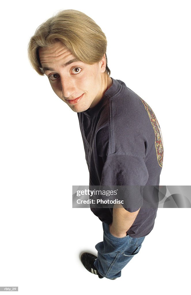 Teenage Boy With Longer Dark Blonde Hair And Brown Eyes Wearing A Purple  Tshirt Blue Jeans And Black Soccer Shoes Looks Up Into The Camera With Big  Eyes And A Slight Smile